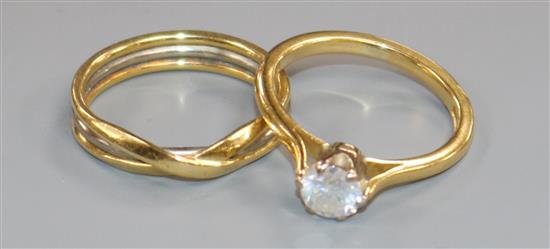 An 18ct gold and solitaire diamond ring with two colour gold wedding band.